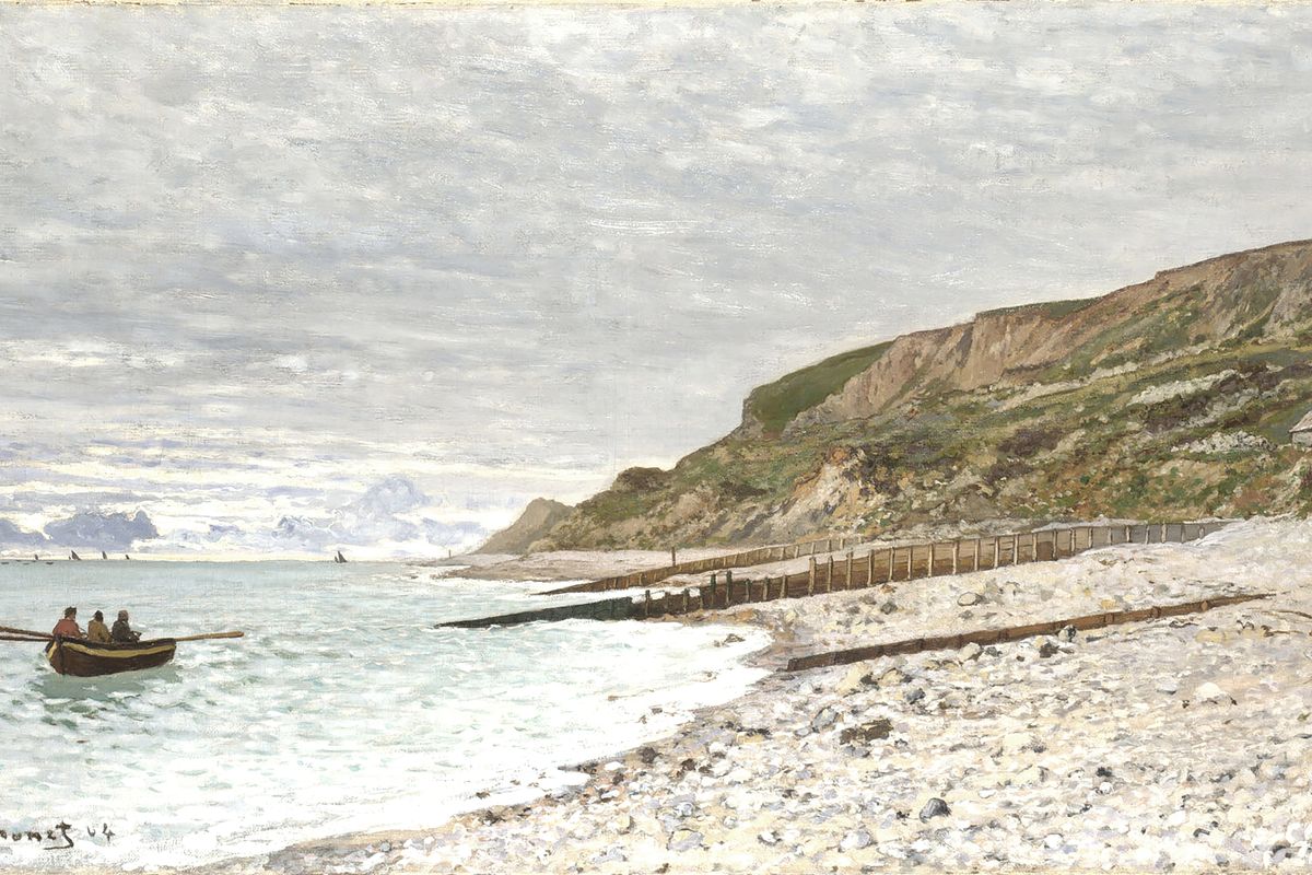 Three figures in a wooden rowboat near a rocky pebble beach beneath tall green-capped chalk cliffs on an overcast day.