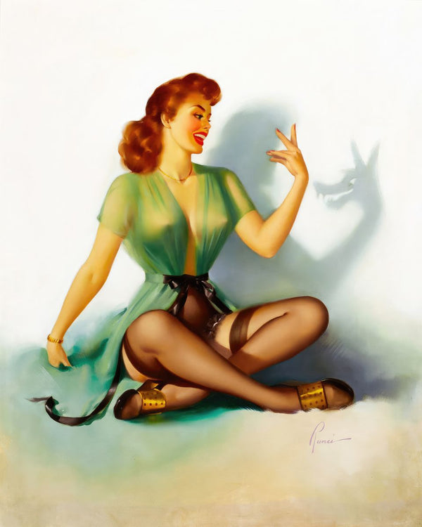 A seated red-haired woman in a sheer green robe makes a bird shadow puppet on a white wall with her raised right hand.