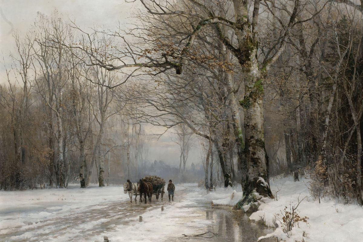 Two horses pulling a wood-loaded cart along a snowy forest road, led by a man on foot, with bare winter trees on both sides a